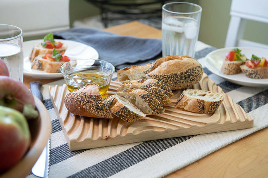 Crafted from sustainable & locally sourced Maple hardwood, these cutting boards completely support the bread, but have deep grooves to catch crumbs.