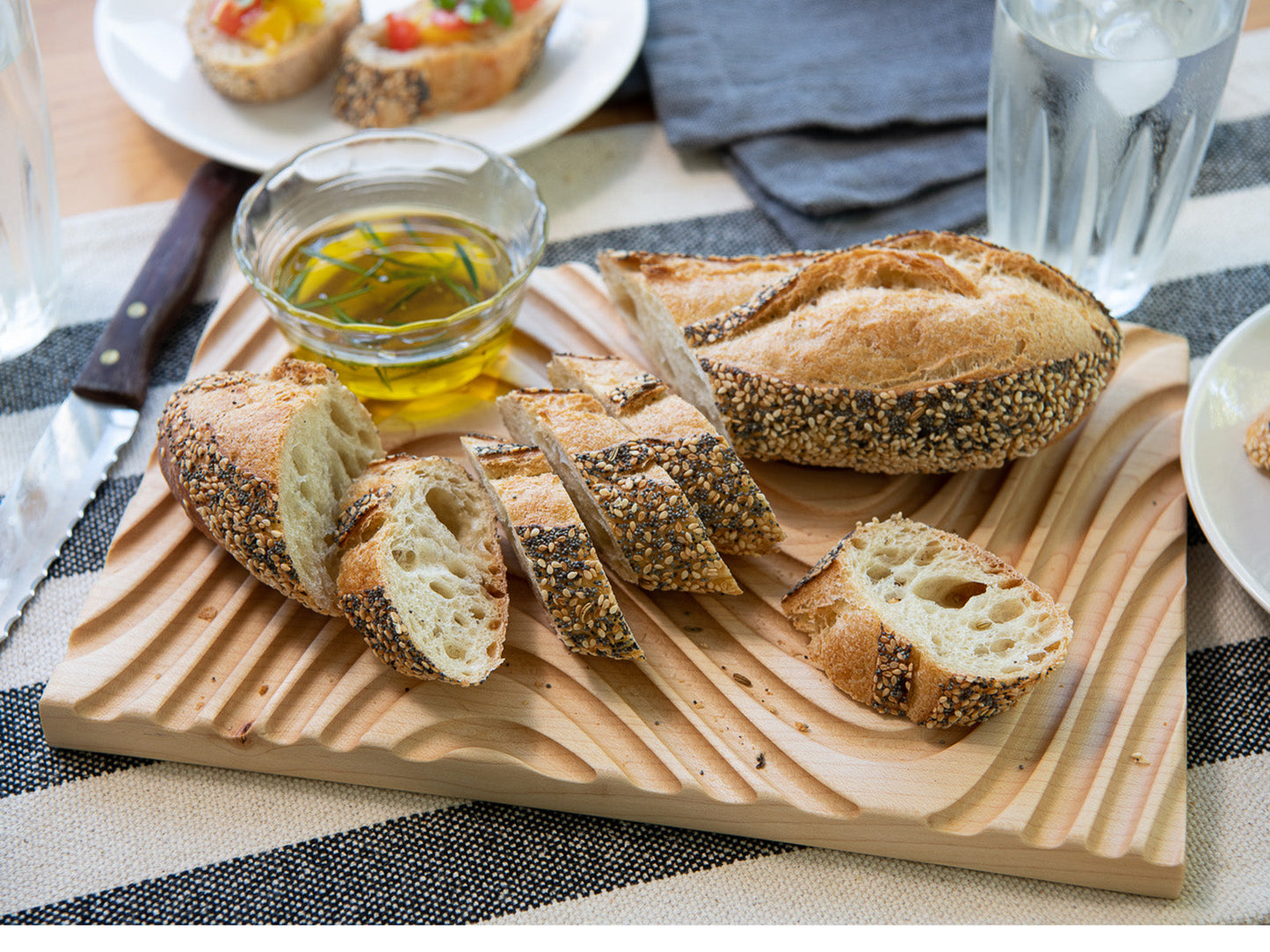 Crafted from sustainable & locally sourced Maple hardwood, these cutting boards completely support the bread, but have deep grooves to catch crumbs. 