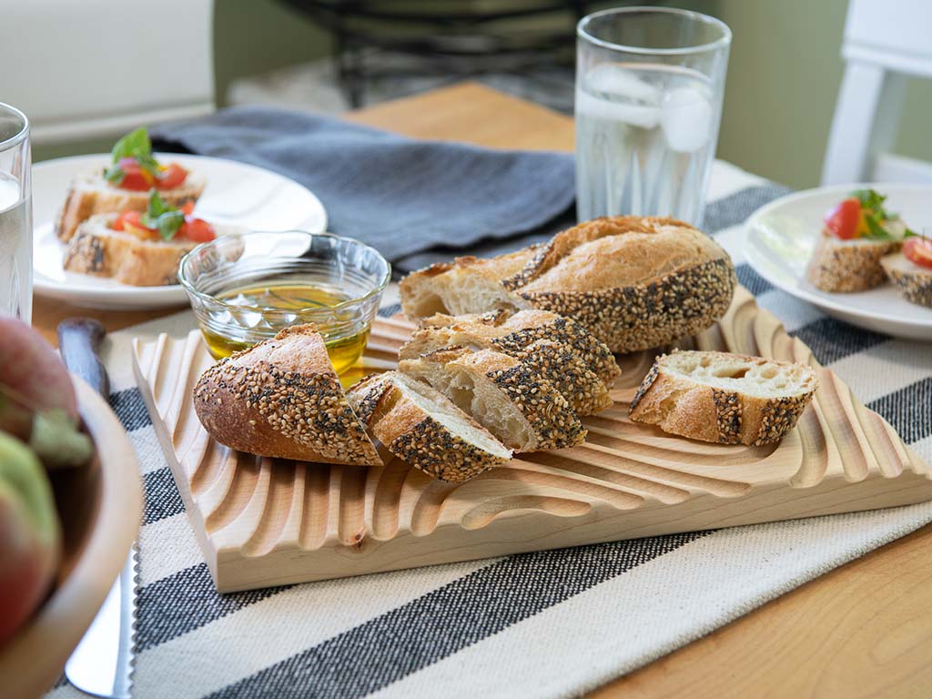 Crafted from sustainable & locally sourced Maple hardwood, these cutting boards completely support the bread, but have deep grooves to catch crumbs.