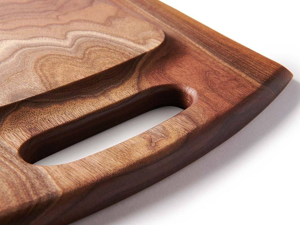 The Marsh charcuterie board features a raised bottom with carved handles in each end for easy lifting and carrying.